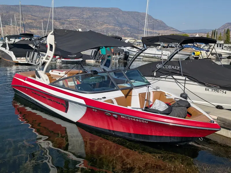 Wake surf boat at a dock